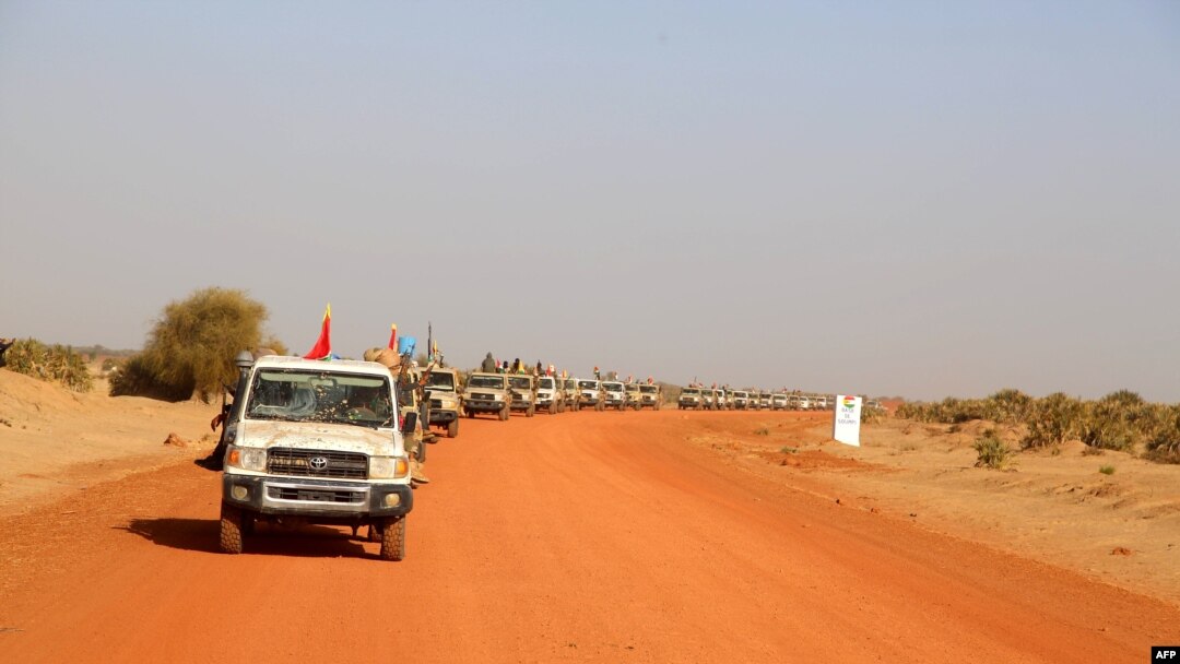 FILE - A convoy of vehicles of the Coalition of the People of Azawad (CPA) are seen patrolling an area near the Mali-Mauritania border to protect local populations from insecurity related to unrest caused by bandits, in Soumpi, Jan. 22, 2020.