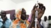 FILE - Staff members of a teaching hospital receive the first vaccination treatment for yellow fever in El Geneina, West Darfur, Nov. 14, 2012.