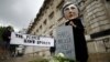 A protester wearing a Theresa May mask is seen the day after Britain's election in London, June 9, 2017. 