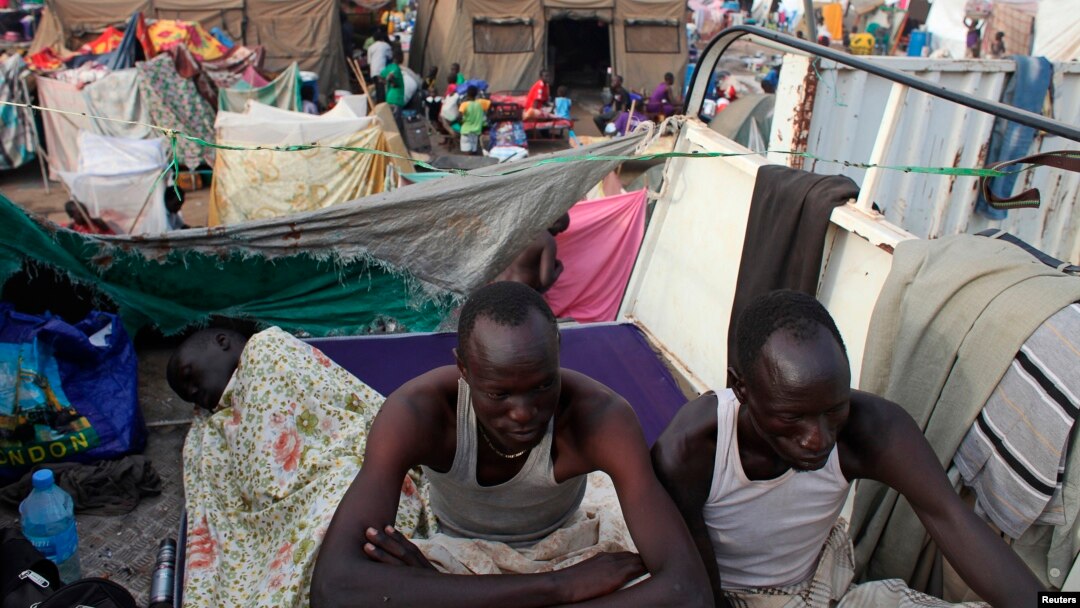 Displaced men rest in an improvised shelter at Tomping camp, where some 17,000 displaced people who fled their homes after violence erupted in South Sudan's capital Juba in mid-December are being sheltered by the United Nations, in Juba Jan. 10, 2014. 