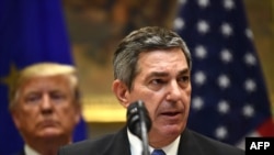 FILE - European Union Ambassador to the U.S. Stavros Lambrinidis speaks as President Donald Trump looks on during an event at the White House, Aug. 2, 2019, in Washington.