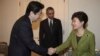 South Korean President Park Geun-hye, right, shakes hands with Japanese Prime Minister Shinzo Abe, left, as U.S. President Barack Obama looks on before their trilateral meeting at the U.S. Ambassador&#39;s Residence in the Hague, Netherlands, Tuesday, March 2