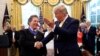 President Donald Trump shakes hands with economist Arthur Laffer after awarding him the Presidential Medal of Freedom, June 19, 2019, in the Oval Office of the White House in Washington. 