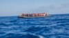 FILE - A rubber boat with 129 migrants on board, among them 60 women, is seen sailing out of control about 15 miles north of Al Khums, Libya, Aug. 1, 2017.