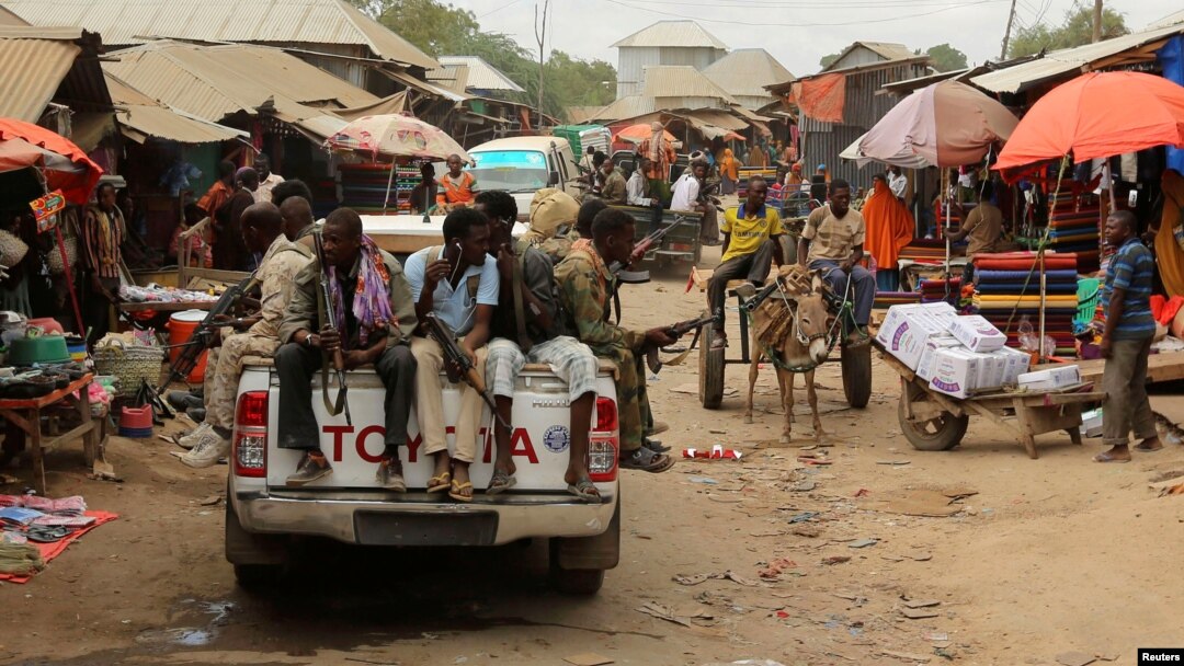 Somali soldiers patrol a street market following a suicide car bomb and gun attack on Tuesday that killed 11 people in Afgoye, Somalia, Oct. 19, 2016. 
