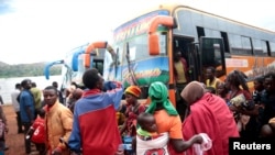 FILE: Burundian refugees get off from a bus which transported them from Tanzania to neighbouring Burundi, as part of a repartition program, at the Nyabitare transit site, in the Gisuru commune, Ruyigi province, Burundi, Oct. 3, 2019.