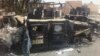 Iraqi army armored vehicles are seen burned on a street of the northern city of Mosul, Iraq, Thursday, June 12, 2014. 