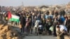 Palestinians stream back to Gaza City and find devastation 