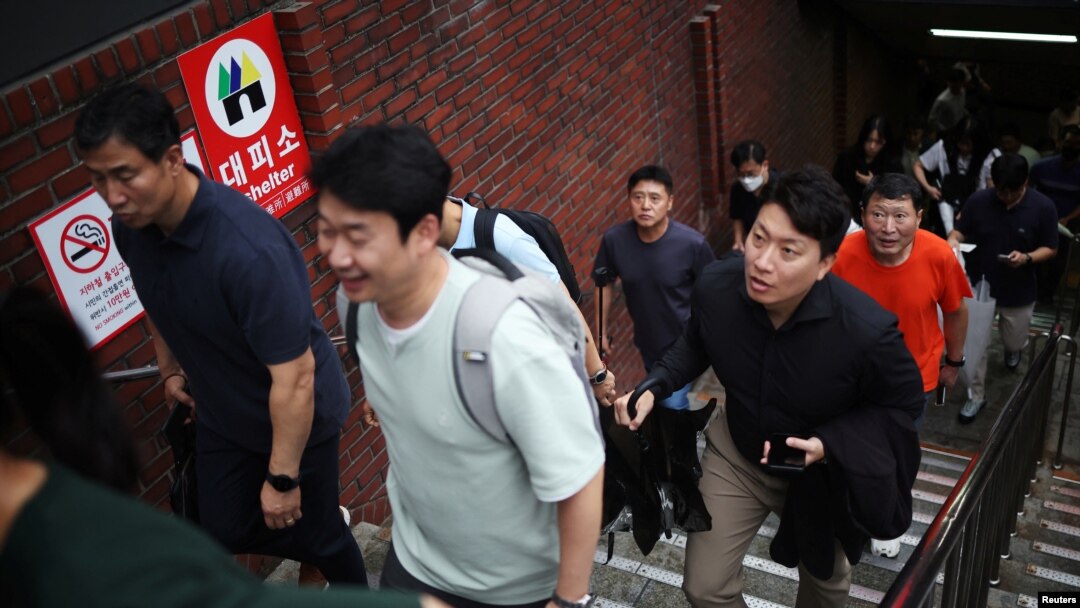 Pedestrians leave a subway station used as a shelter for emergency after a nationwide civil defense drill, which is being conducted for the first time in six years, to prepare in case of an air raid, in central Seoul, South Korea, Aug. 23, 2023