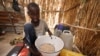 FILE - A boy shows a food ration he received at an internally displaced persons (IDP) camp at Gamboru, Borno state, Nigeria, April 27, 2017.