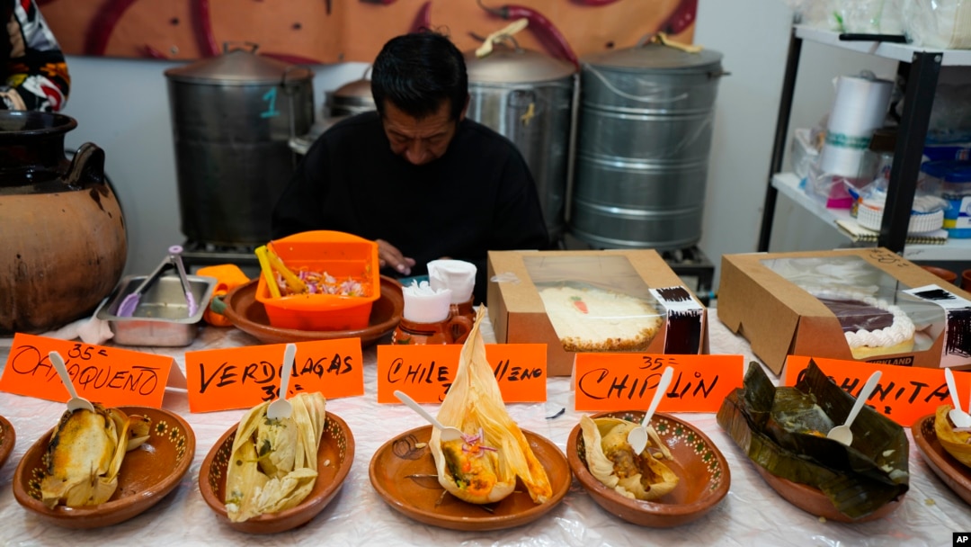 Tamales of different styles are displayed on a table during the tamales fair at the Ixtapalapa neighborhood of Mexico City, Friday, Jan. 27, 2023. (AP Photo/Fernando Llano)