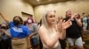 Allie Ugley, middle, an Allen County resident, holds back tears after hearing the news that the "No" votes won on a proposed amendment to the Kansas Constitution for Constitutional Freedom election watch party in Overland Park, Kansas, Aug. 2, 2022. 