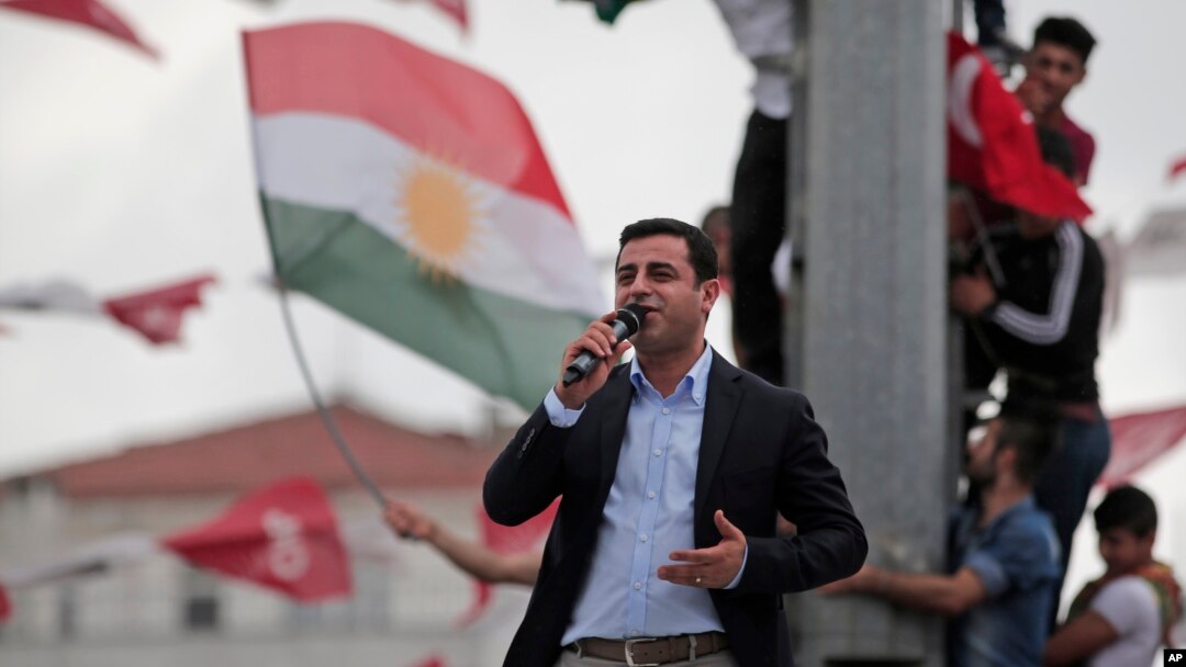 Ahead of Sunday's election, Selahattin Demirtas, head of the pro-Kurdish Peoples' Democratic Party (HDP), delivers a speech from the top of his election campaign bus at a rally in Istanbul, Turkey, June 6, 2015.