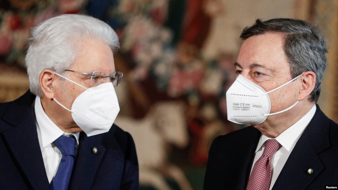 Italian President Sergio Mattarella and Prime Minister Mario Draghi wearing face masks speak after the new cabinet ministers swearing-in ceremony, at the Quirinale Presidential Palace in Rome, Italy, Feb. 13, 2021. 