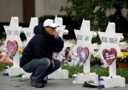 FILE - A person pauses in front of Stars of David with the names of those killed in a deadly shooting at the Tree of Life Synagogue in Pittsburgh, Oct. 29, 2018.