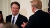 Supreme Court nominee Judge Brett Kavanaugh smiles next to U.S. President Donald Trump in the East Room of the White House in Washington, July 9, 2018