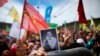 FILE - A woman holds a photograph of former co-leader of pro-Kurdish Peoples' Democratic Party, or HDP, Selahattin Demirtas, during the Newroz celebrations, marking the start of spring, in Istanbul, March 21, 2018.