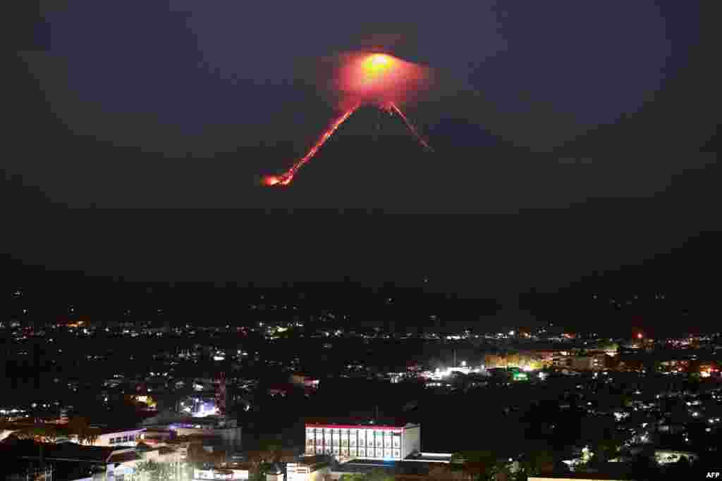 Lava from Mayon volcano is seen as it erupts in Legazpi. The Philippines raised the alert level for the country&#39;s most active volcano twice in 24 hours, meaning that a hazardous eruption is possible within days.