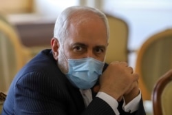 FILE - Iran's Foreign Minister Mohammad Javad Zarif looks on during a meeting with International Atomic Energy Agency (IAEA) Director-General Rafael Grossi in Tehran, Feb. 21, 2021.
