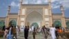 Afghan men leave after Eid Al-Fitr prayers in Eid Gah mosque in Kabul, Afghanistan, July 17, 2015. Eid al-Fitr prayer marks the end of the holy fasting month of Ramadan.