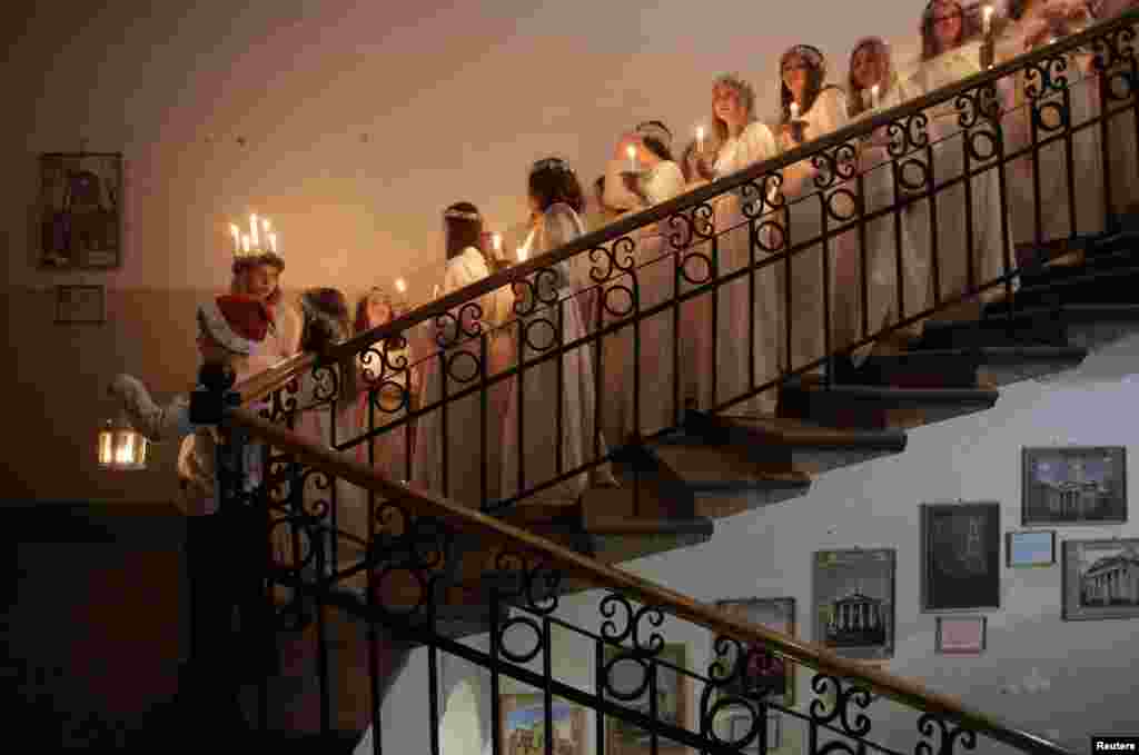 Youths wait to perform during the celebration of St. Lucia's Day at the Swedish Evangelical and Lutheran church of St. Katarina in St. Petersburg, Russia, Dec. 13, 2017.