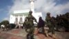 FILE - Soldiers serving in the African Union Mission in Somalia (AMISOM) patrol outside a Mosque during Eid al-Fitr prayers, marking the end of the fasting month of Ramadan at a Mosque in Somalia's capital Mogadishu, July 17, 2015.