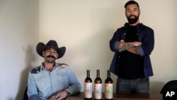 In this Dec. 22, 2017, photo, Alex Howe, right, and Chip Forsythe, co-founders of Rebel Coast, pause for photos with their cannabis-infused wine in Los Angeles.
