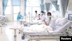 A screen grab shows boys rescued from the Thai cave wearing mask and resting in a hospital in Chiang Rai, Thailand from a July 11, 2018 handout video. (Government Public Relations Department (PRD) and Government Spokesman Bureau/Handout) 