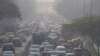 Commuters drive amidst morning haze and toxic smog in New Delhi, India, Nov. 17, 2021. 