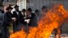 Ultra-Orthodox Jewish men pray as they burn leaven in the Mea Shearim neighbourhood of Jerusalem, ahead of the Jewish holiday of Passover, April 14, 2014.