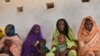 FILE - Mothers wait for their children to be examined for signs of malnutrition at a walk-in nutrition clinic in Barrah, a desert village in the Sahel belt of Chad, April 20, 2012. 