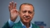 Turkish President Recep Tayyip Erdogan reacts during an election rally in Istanbul, June 23, 2018. 