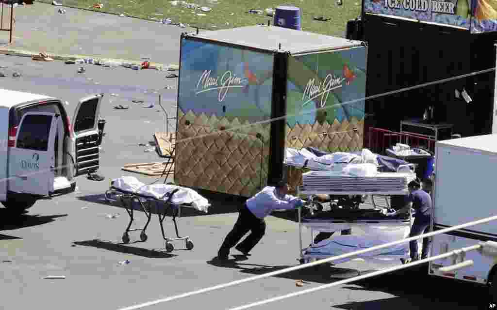 Investigators load bodies from the scene of a mass shooting at a music festival near the Mandalay Bay Resort and Casino on the Las Vegas Strip, in Las Vegas, Nevada, Oct. 2, 2017.