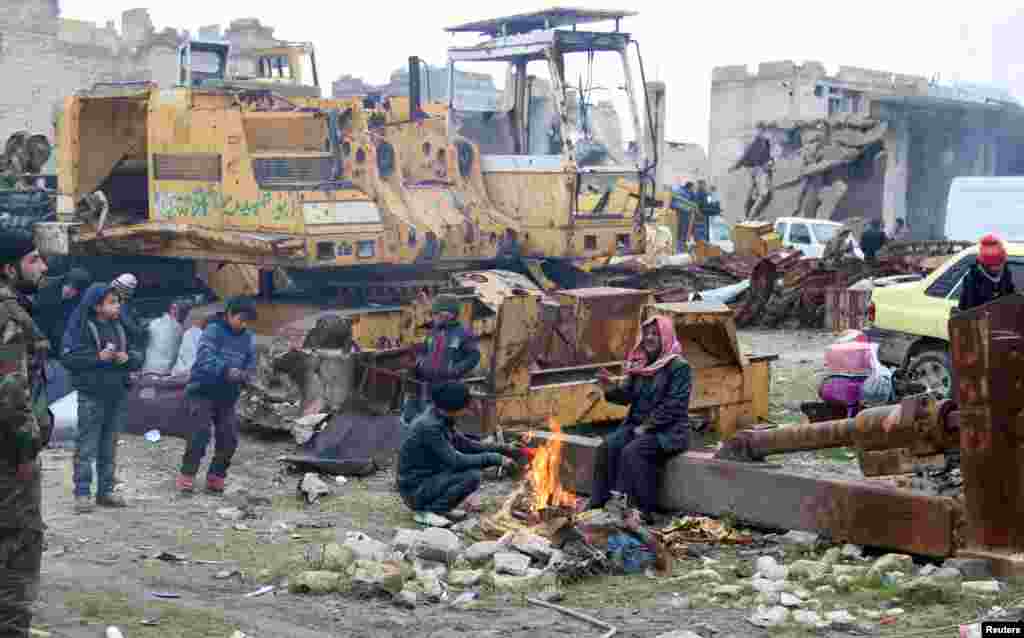 People wait to be evacuated from a rebel-held sector of eastern Aleppo, Syria Dec. 16, 2016. 