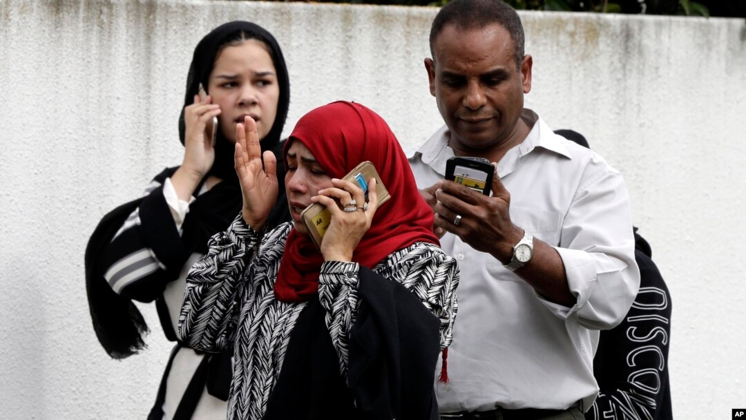 People wait outside a mosque in central Christchurch, New Zealand, March 15, 2019.