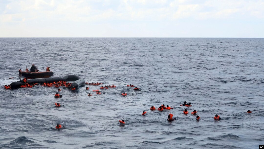 Refugees and migrants are rescued by members of the Spanish NGO Proactiva Open Arms, after leaving Libya trying to reach European soil aboard an overcrowded rubber boat in the Mediterranean sea, Nov. 11, 2020.