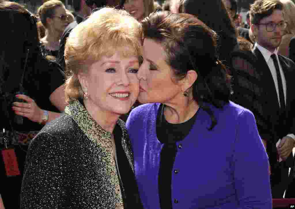 Debbie Reynolds and Carrie Fisher arrive at the Primetime Creative Arts Emmy Awards, Sept. 10, 2011, in Los Angeles.