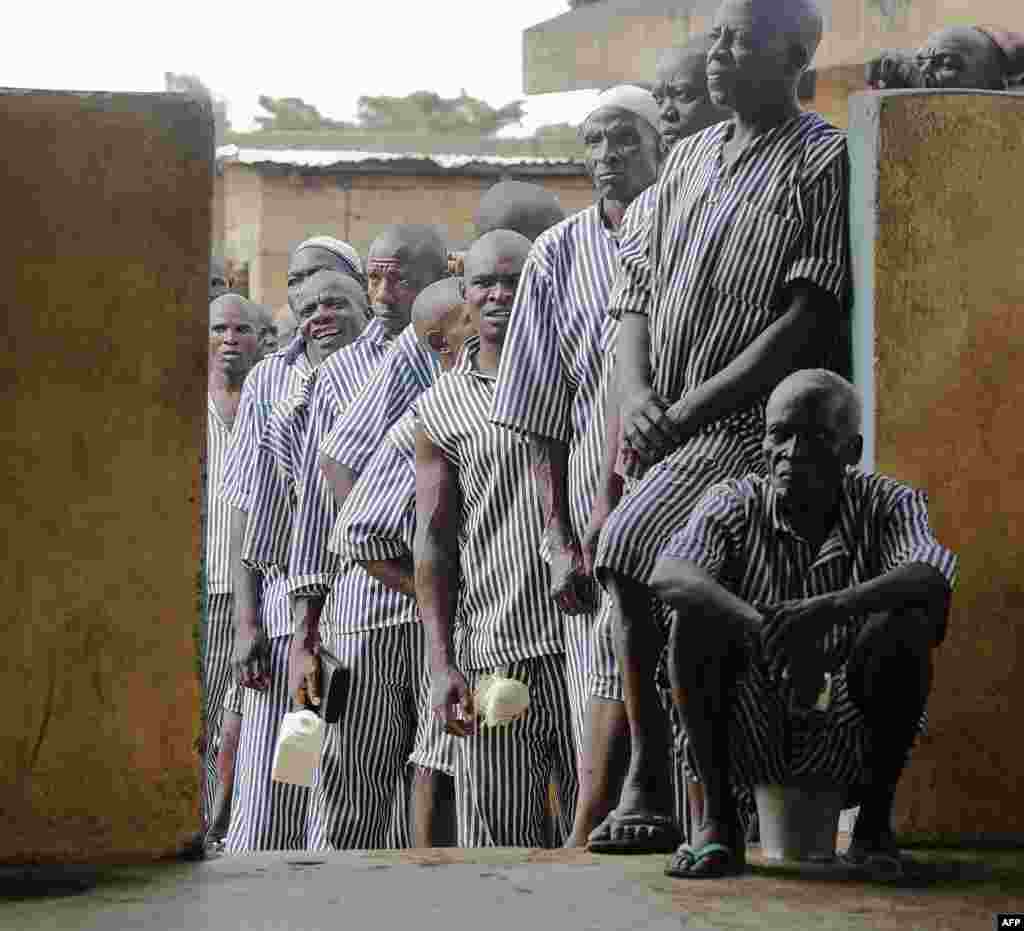 Kenyan inmates wait in line to cast their vote in Kisumu, on Lake Victoria. This is the first time that inmates in Kenya are allowed to vote. The inmates cast ballots for the presidential candidates only. Kenyans began voting in general elections headlined by a too-close-to-call battle between incumbent Uhuru Kenyatta and his rival Raila Odinga, sparking fears of violence in east Africa's richest economy.