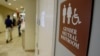FILE- A sign marks the entrance to a gender-neutral restroom at the University of Vermont in Burlington, Vermont.