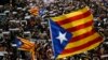Thousands of people rally outside the regional presidential palace in Sant Jaume Square during a general strike in Barcelona, Spain, Nov. 8, 2017. 