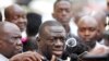 FILE - Uganda's main opposition leader Kizza Besigye (C) speaks to the media in Uganda's capital Kampala, Oct. 4, 2016.