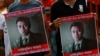 FILE - People carry portraits of student activist Nazimuddin Samad as they attend a rally to demand arrest of three motorcycle-riding assailants who hacked and shot Samad to death, in Dhaka, Bangladesh, April 8, 2016.
