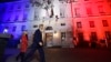 U.S. Secretary of State John Kerry (C), next to U.S. ambassador to France Jane D. Hartley, leaves after delivering a speech at the U.S. embassy in Paris illuminated with the colors of the French national flag, Nov. 16, 2015.