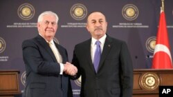 Turkish Foreign Minister Mevlut Cavusoglu, right, shakes hands with U.S. Secretary of State Rex Tillerson, after a joint news conference following their meeting in Ankara, Turkey, Feb. 16, 2018.