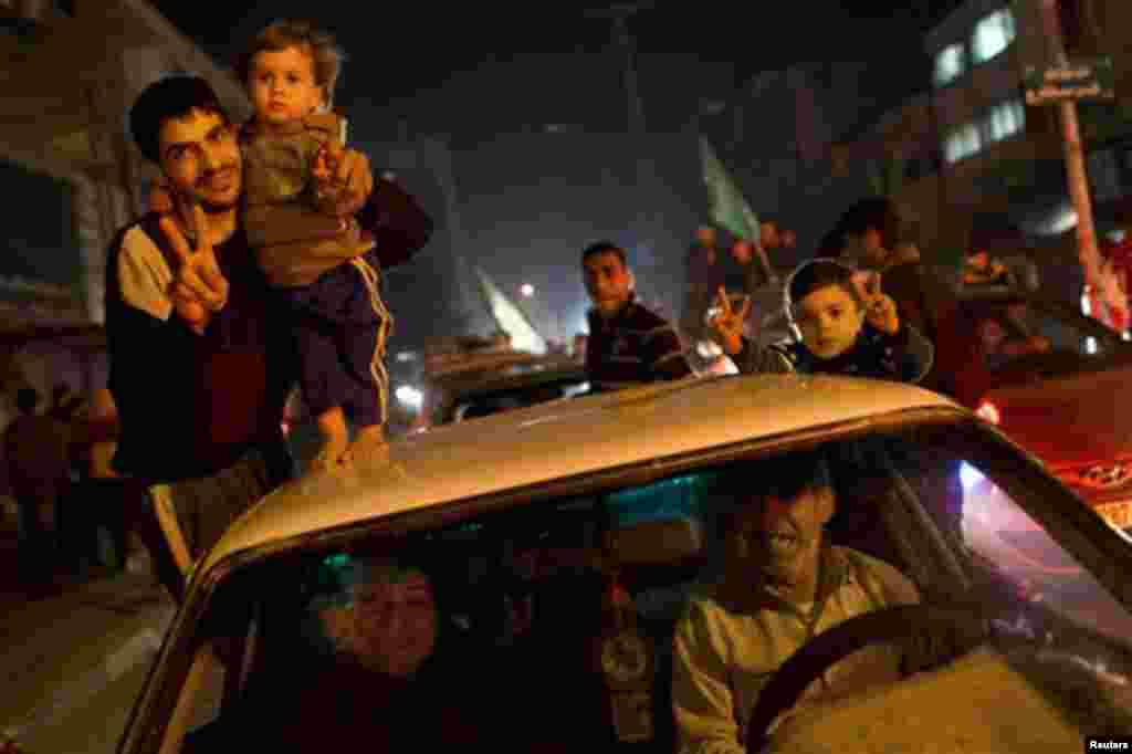 Palestinians celebrate the cease-fire between Israel and Hamas, Gaza City, Nov. 21, 2012.