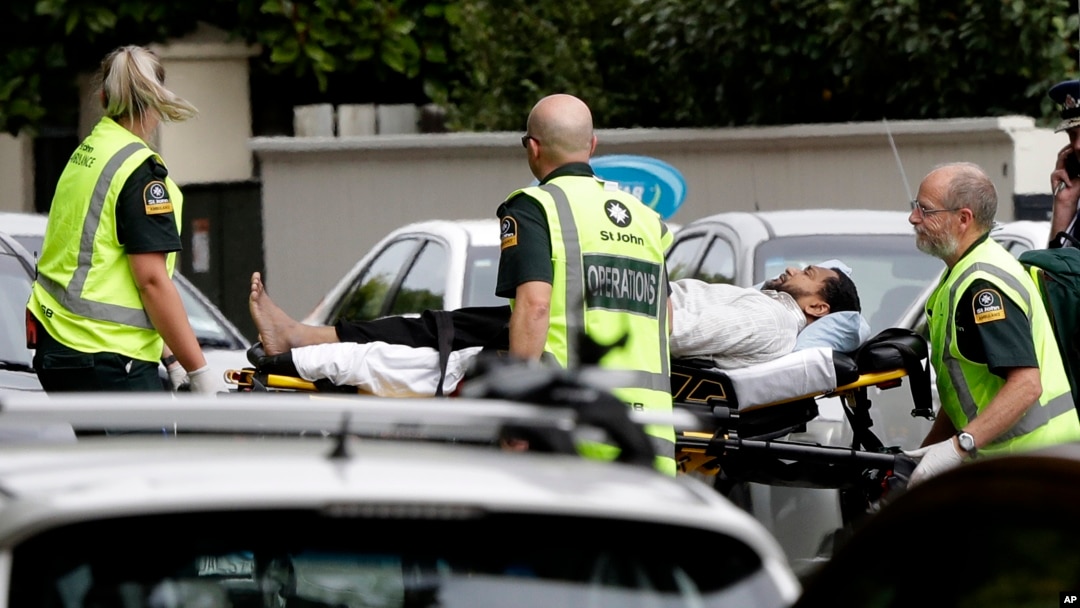 Ambulance staff take a man from outside a mosque in central Christchurch, New Zealand, March 15, 2019. A witness says many people have been killed in a mass shooting at a mosque in the New Zealand city of Christchurch.