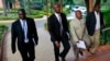 M23 rebel negotiators are seen heading into the final leg of negotiations with the Congolese government, in Kampala October 19, 2013. 