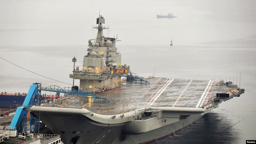 FILE - China's first aircraft carrier, which was renovated from an old aircraft carrier that China bought from Ukraine in 1998, is seen docked at Dalian Port, in Dalian, Liaoning province September 22, 2012. 