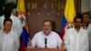 Commander of the Revolutionary Armed Forces of Colombia or FARC, Rodrigo Londono, better known as Timochenko or Timoleon Jimenez talks to the press, accompanied by Ivan Marquez, right, chief negotiator of the Revolutionary Armed Forces of Colombia and Pablo Catatumbo, left, chief of the FARC's western bloc, in Havana, Cuba, Sunday, August 28, 2016. 