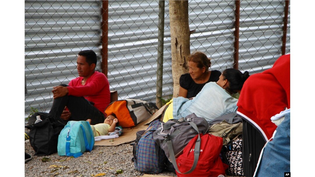 Venezuelan migrants rest with their belongings after crossing the border to Pacaraima, in Roraima state, Brazil, Aug. 20, 2018.